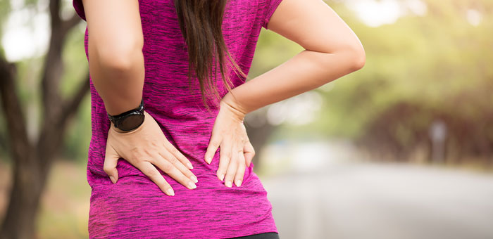 patient suffering from back pain needing a chiropractor in Valley Village