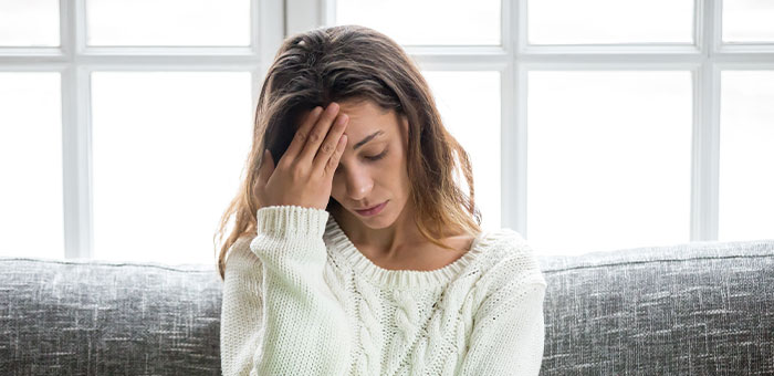 patient suffering from headaches needing a chiropractor in Valley Village